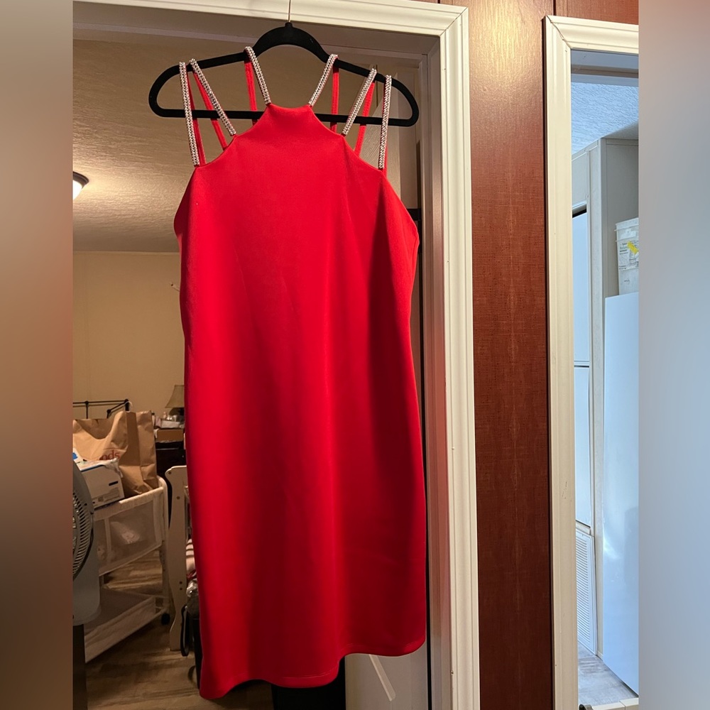 Red knee length dress that has 3 rows of rhinestones for shoulders.